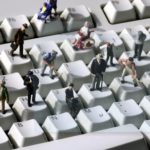 GERMANY, Bonn, "Online" - Human miniatures on a computer keyboard.